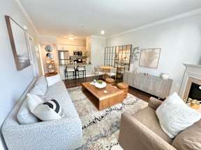 A living room with a grey couch and a coffee table.