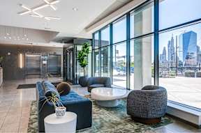 A modern lobby with a view of the city skyline.