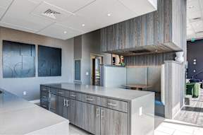 A modern kitchen with a large island and wooden accents.