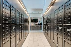 A row of black mailboxes with numbers ranging from 119 to 128.