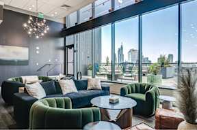 A modern living room with a view of the city skyline.