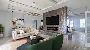 A living room with a fireplace and a flat screen TV.