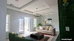 A living room with a couch, chairs, and a coffee table.