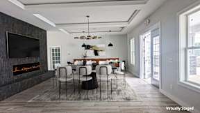 A modern dining room with a fireplace and a large table.