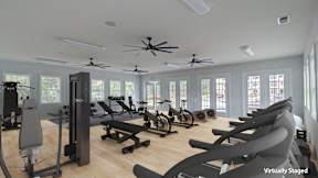 A virtual staging of a gym with various exercise equipment.