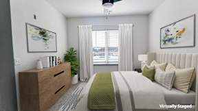 A bedroom with a bed, dresser, and window with curtains.