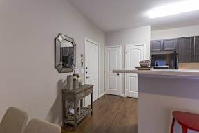 A small room with a wooden floor and white walls.