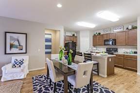 A dining room with a table set for four.