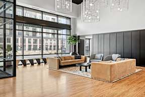 A modern living room with a large window and a view of a cityscape.