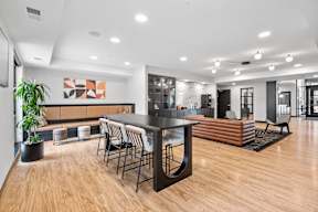 A modern living room with a wooden floor and a black table.