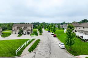 A residential street with cars parked on the side.