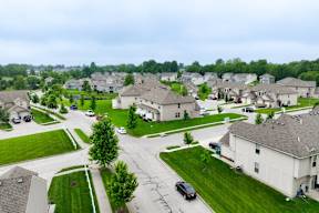 A residential area with houses and cars.