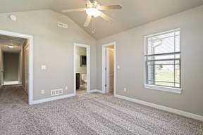 A room with a ceiling fan and a window.