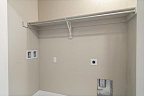 A white shelf is mounted on a wall.