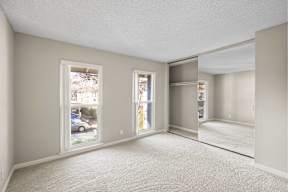 Empty room with white walls and carpet.