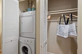 A white washing machine and dryer in a small laundry room.
