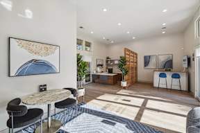 A modern living room with a dining table and chairs.