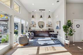 A modern living room with a grey sofa and a wooden coffee table.