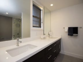 A bathroom with a sink and mirror.