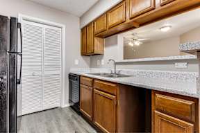 A kitchen with wooden cabinets and a white countertop.