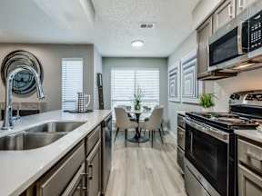 A modern kitchen with a dining table and chairs.