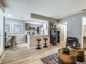 A kitchen with a bar stool and a counter.