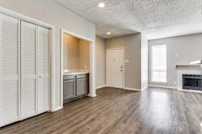A room with a fireplace and a wooden floor.