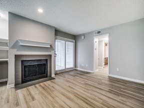 A living room with a fireplace and sliding glass doors.