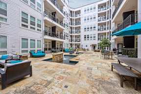 A courtyard with a pool and seating area.