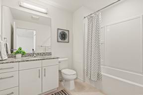 A bathroom with a toilet, sink, and bathtub.