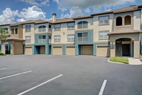an empty parking lot in front of an apartment building