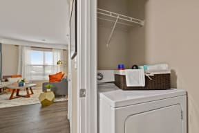 Riverstone Apartments In-Unit Laundry Room with Full-Size Washer/Dryer and Shelving