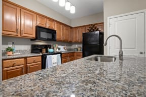 Renovated Kitchen with Granite Countertops and Farmhouse Style Sink