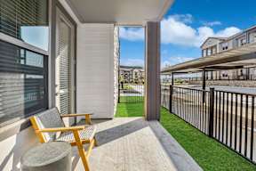 A patio with a chair and table is shown.