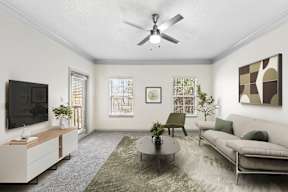 A living room with a grey couch, a coffee table, a television, and a painting on the wall.