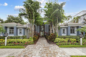 A row of houses with a brick pathway leading to the front doors.