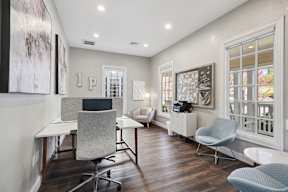 A room with a desk and chairs.
