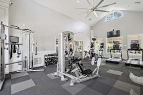 A spacious home gym with a variety of exercise equipment.