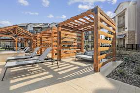 Poolside cabanas with lounge chairs and daybeds