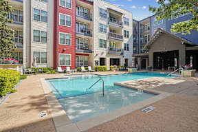 A swimming pool in front of apartment buildings.