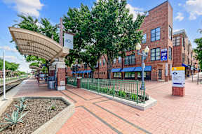 A train station with a red brick building and a blue awning.