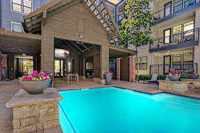 A large outdoor swimming pool in front of a house.