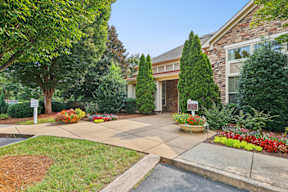 A house with a front yard and a driveway.