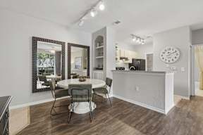 A dining room with a white table and chairs.