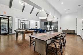 A dining room with a long table and chairs.