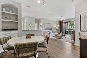 A dining room with a round table and chairs.