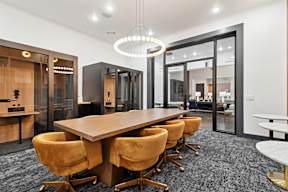 A conference room with a long table and chairs.