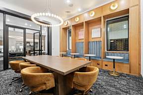 A conference room with a long table and chairs.