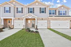 A two-story house with a front yard and a garage.