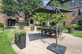 A patio with a table and chairs under a canopy.